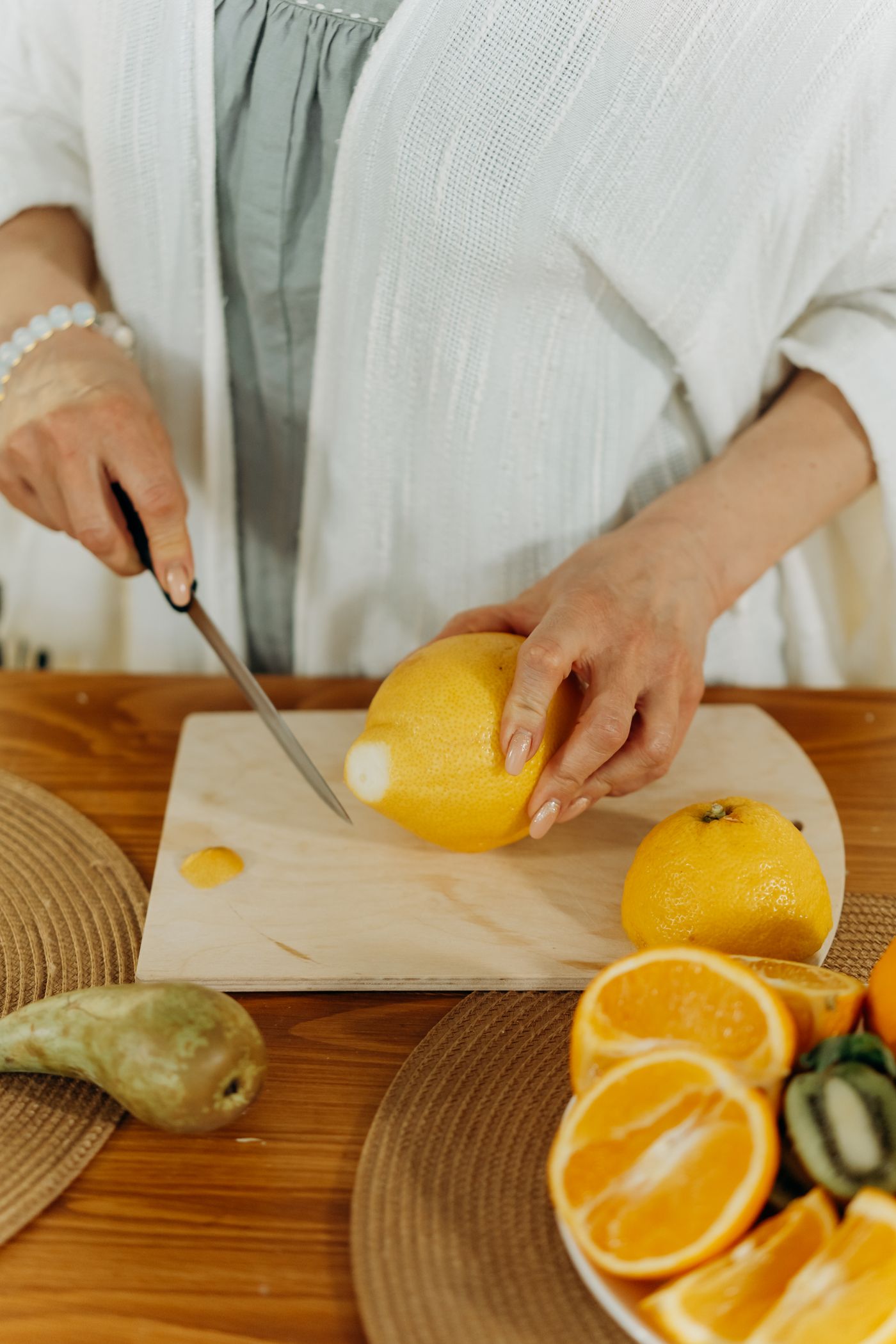 A mature woman preparing her morning routine in her kitchen